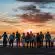 people standing on shore during golden hour